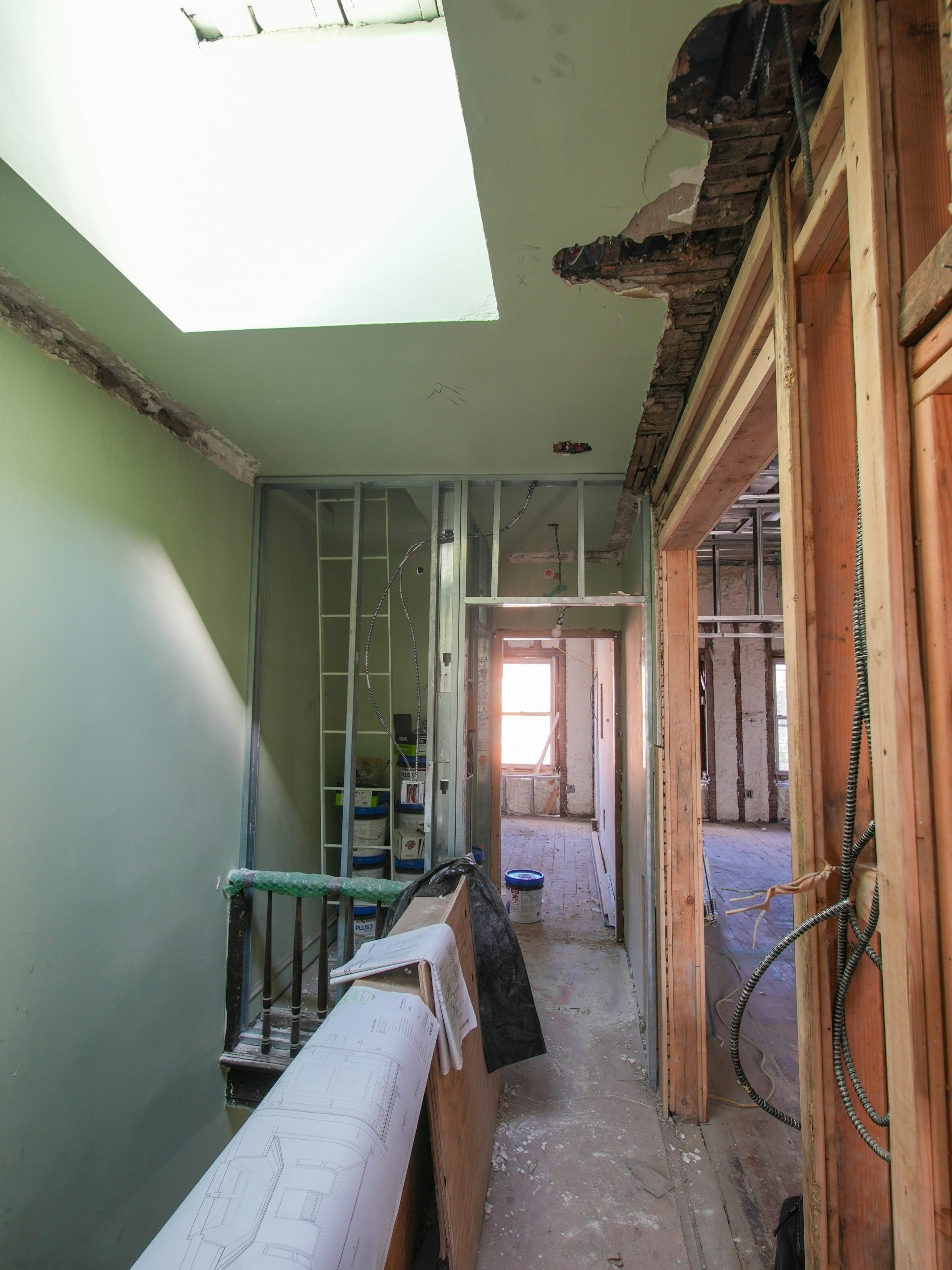 Interior hallway under renovation with exposed framing.